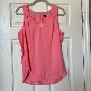 Soft peachy pink blouse.